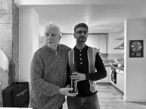 Brian Griffin and another man holding a bottle of Neotempo wine